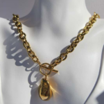 Stylish chunky stainless steel necklace featuring an asymmetric charm.