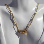 Stylish chunky gold plated stainless steel necklace featuring two tonecharms