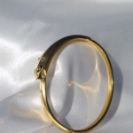 Gold plated stainless steel bangle bracelet.