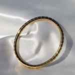 Gold plated stainless steel bangle bracelet.