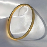 Gold plated stainless steel bangle bracelet.