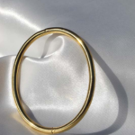 Gold plated stainless steel bangle bracelet.