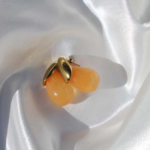 Gold plated stainless steel earrings with a drop shape semiprecious gem.