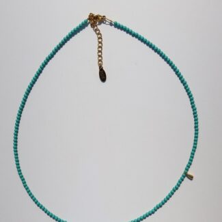 Necklace made with semiprecious gems and charm of goldplated stainless steel